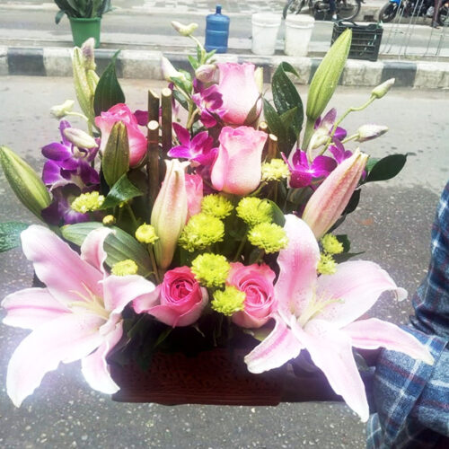combination of pink roses lily orchids mums bouquet