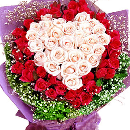 heart shaped bouquet of white pink roses