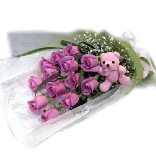 wonderful purple rose hand bouquet with a cute teddy bear