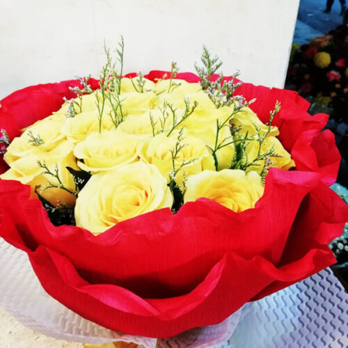 yellow rose presented in a round bouquet