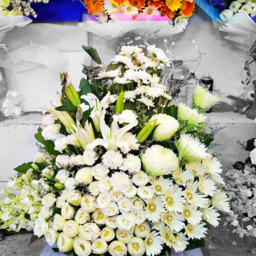 whitish lovely large basket of different flowers