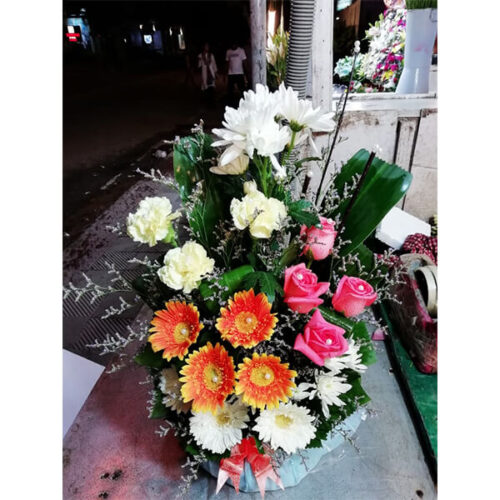 white flower bouquet with pink and orange touch